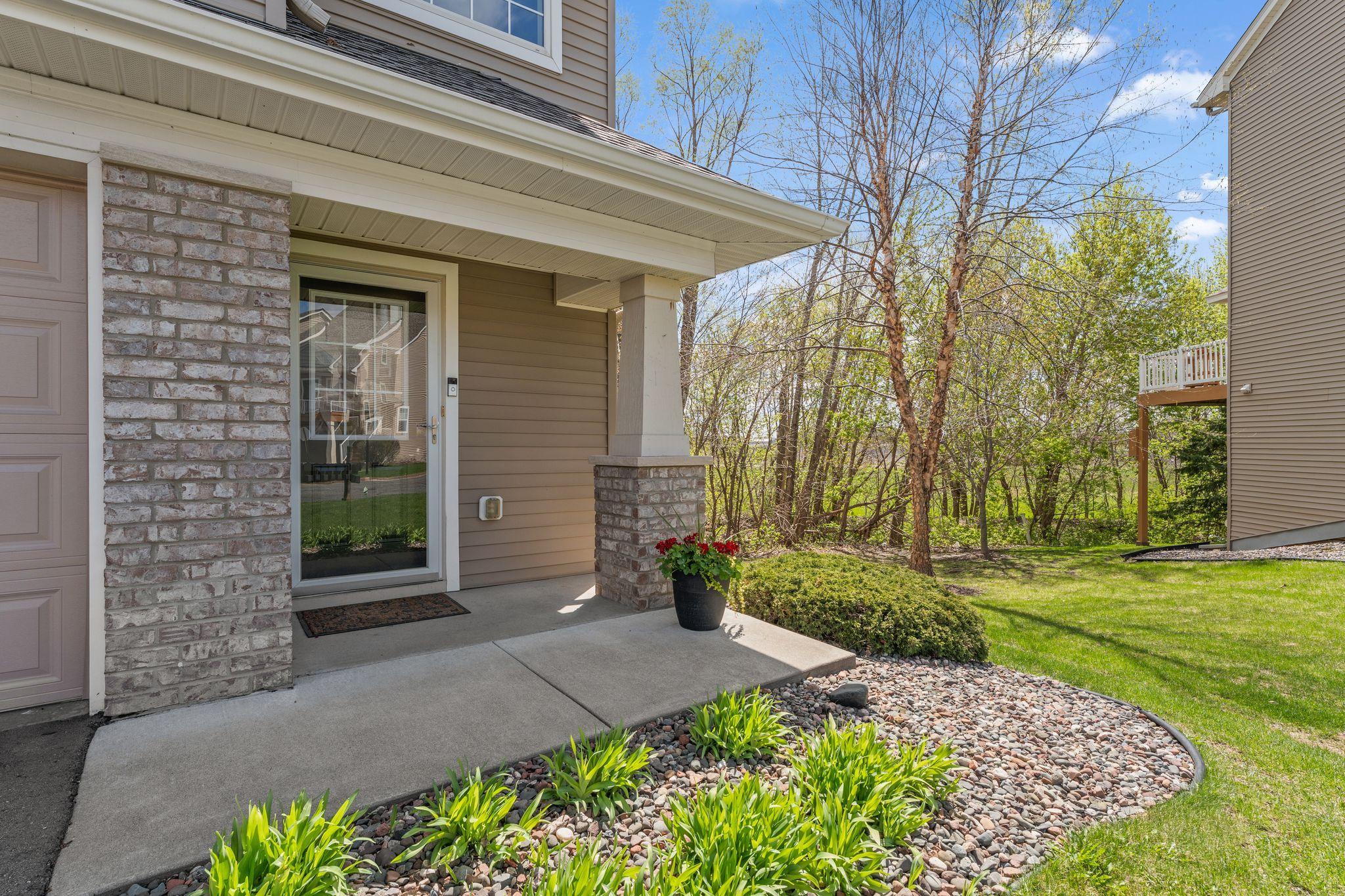 Covered front entry with charming brick accents and space to great guests.