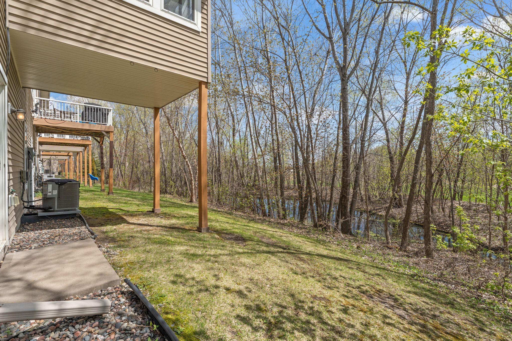 Private backyard with mature trees, open green space, and room to enjoy.