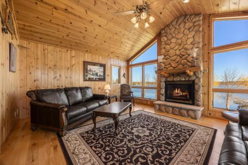 Vaulted Ceiling with Ceiling Fan and Stone Fireplace