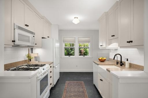 Enamel white kitchen cabinets with matt black hardwood