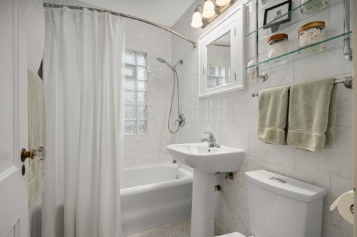 Main floor bath offers the classic white tile