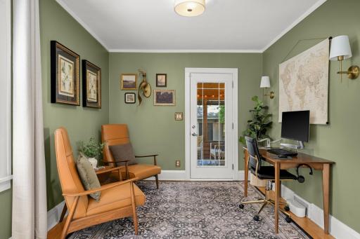 Main floor bedroom that is used as a office offers hardwood floors.