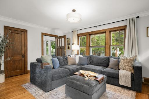 Main floor living room offers hardwood floors and cove ceilings.