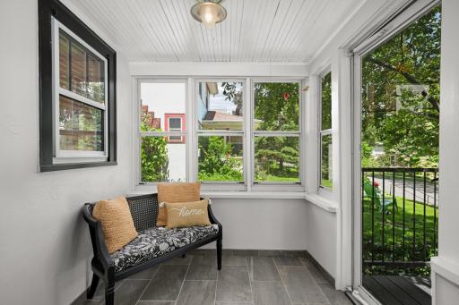 Inviting enclosed front porch showcases the timeless charm of this home
