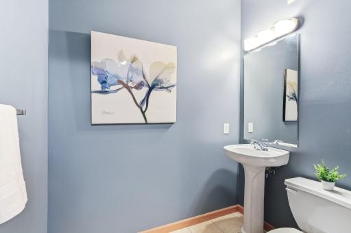 Stylish half bath thoughtfully designed for convenience, featuring modern fixtures and a clean, functional layout—perfect for guests and everyday use.