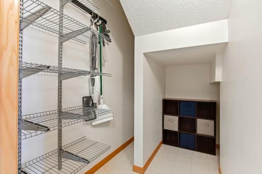 Storage closet featuring built-in shelving for efficient organization, providing a clean and functional space to neatly store household items, linens, and everyday essentials.
