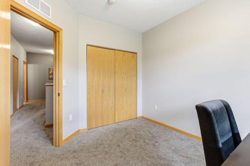 Upper-level second bedroom in the condo offers a comfortable and private space, ideal for guests, a home office, or additional living needs, with convenient access to the full bath and upper-level layout.