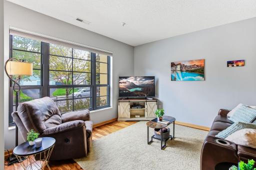 Massive window floods the space with natural light, creating a bright and airy atmosphere while offering expansive views and a stunning focal point for the room.