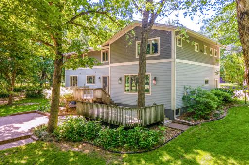 Large deck overlooks the beautifully 1.28-acre yard, offering the perfect setting for outdoor dining and relaxation.