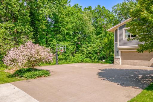 Expansive driveway and basketball hoop provide ample space for recreation, parking, and everyday convenience.