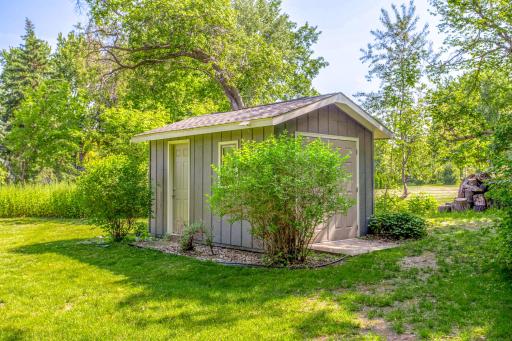 Additional storage shed provides convenient space for tools, equipment, and seasonal storage needs.