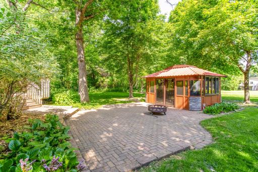 Peaceful outdoor setting with lush landscaping, a spacious yard, and direct access to the gazebo and patio.