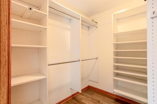 Well-designed walk-in closet featuring built-in shelving systems and ample space for clothing, accessories, and household storage.