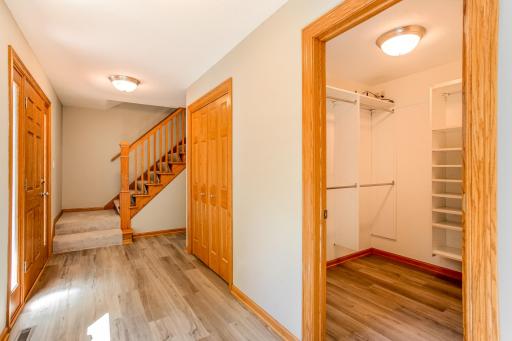 Large walk-in closet with custom shelving and hanging space, providing exceptional organization and storage.