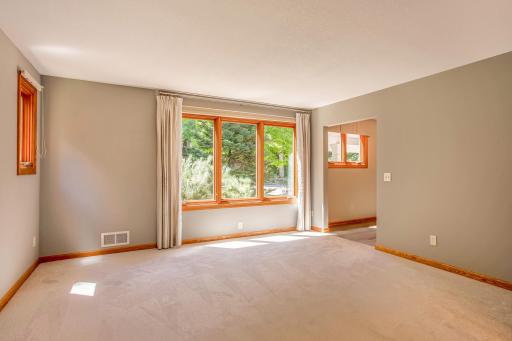 Oversized living area with expansive windows and serene outdoor views, creating a bright and welcoming atmosphere.