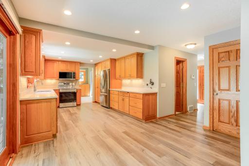 Designed for everyday living and entertaining, this open-concept kitchen offers generous storage, updated LVP flooring, and a spacious buffet, and brand-new stainless-steel appliances.