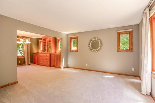 Spacious living room filled with natural light, offering flexible space for entertaining, gathering, or everyday relaxation.