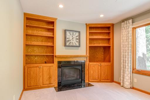 Built-in shelving and a gas fireplace create a warm focal point in this inviting family room, perfect for relaxing or gathering with guests.
