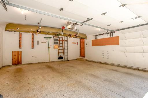 Oversized garage offering epoxy floors, excellent storage solutions, wall-mounted organization systems, and plenty of space for hobbies or workshop needs.
