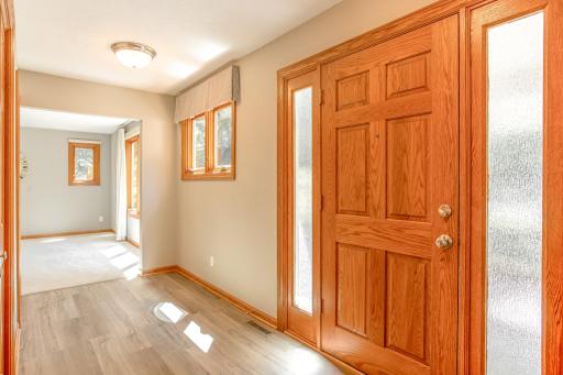 Inviting front entry with warm woodwork, updated flooring, and abundant natural light that sets the tone for the rest of the home.