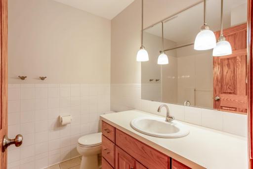 Well-appointed full bath with an oversized vanity, generous counter space, and modern lighting, offering both style and everyday functionality.