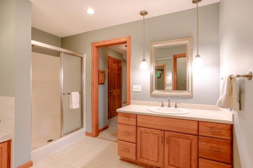 Primary bath with oversized vanity, updated lighting, and a separate shower, offering a comfortable and functional retreat.