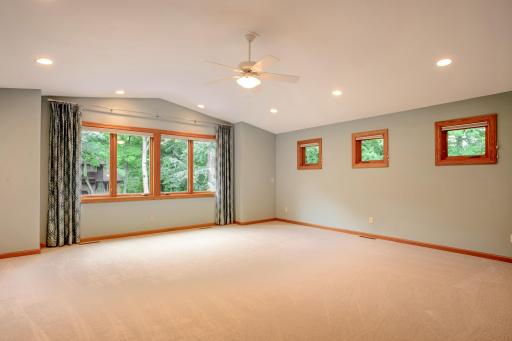 Expansive bonus room with French door entry, vaulted ceiling, and oversized windows that fill the space with natural lightâideal for a family room, media room, or home office.