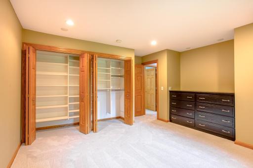 Thoughtfully designed bedroom featuring extensive built-in shelving and storage, ideal for staying organized while maximizing floor space.