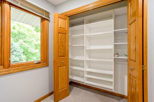 Organized closet with custom shelving and hanging space, providing excellent storage and everyday functionality.