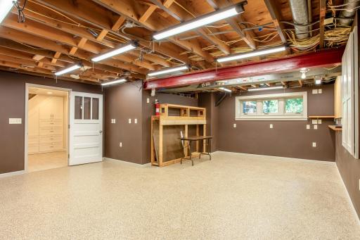Dedicated workspace area with shelving, pegboard storage, and natural light creates an ideal setting for projects and craftsmanship.