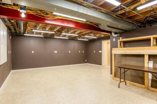Expansive workshop space offers endless flexibility for hobbies, projects, and creative pursuits, with durable flooring, abundant lighting, and ample room to spread out.