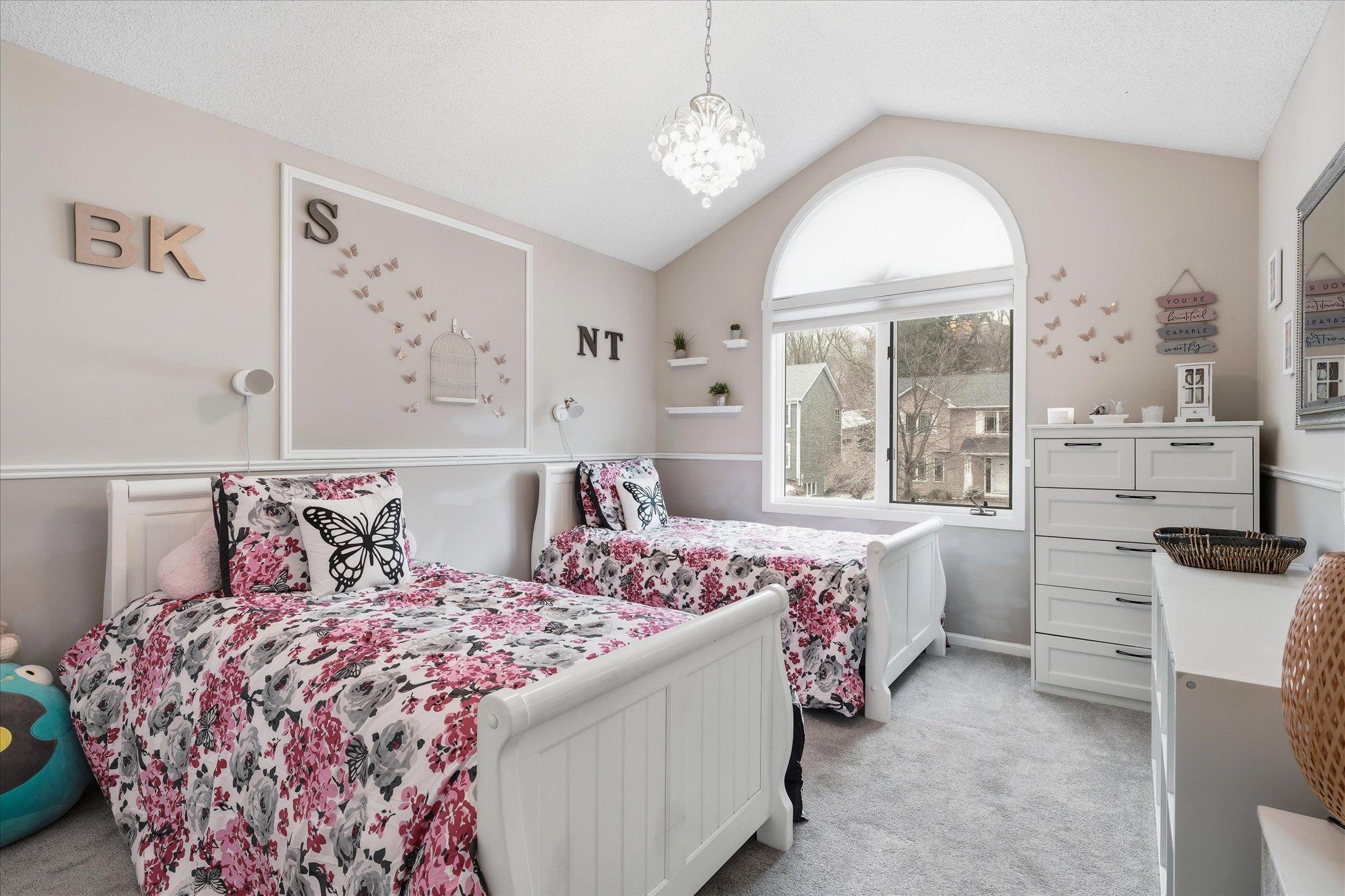 Spacious bedroom with vaulted ceiling, plenty of natural light, perfect for a relaxing retreat.
