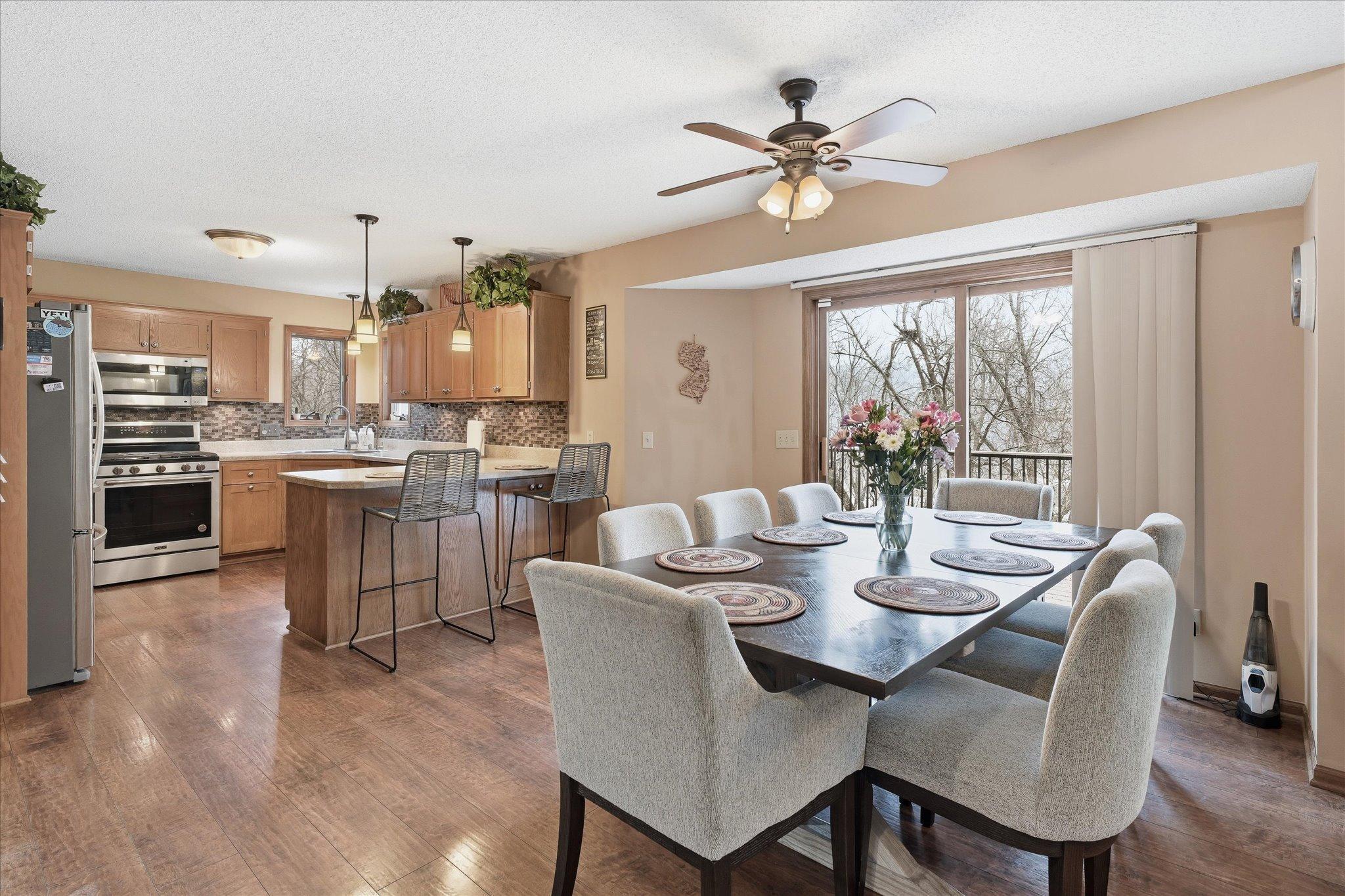 Inviting dining space with scenic wooded views, and a seamless flow to both the kitchen and great room—perfect for entertaining