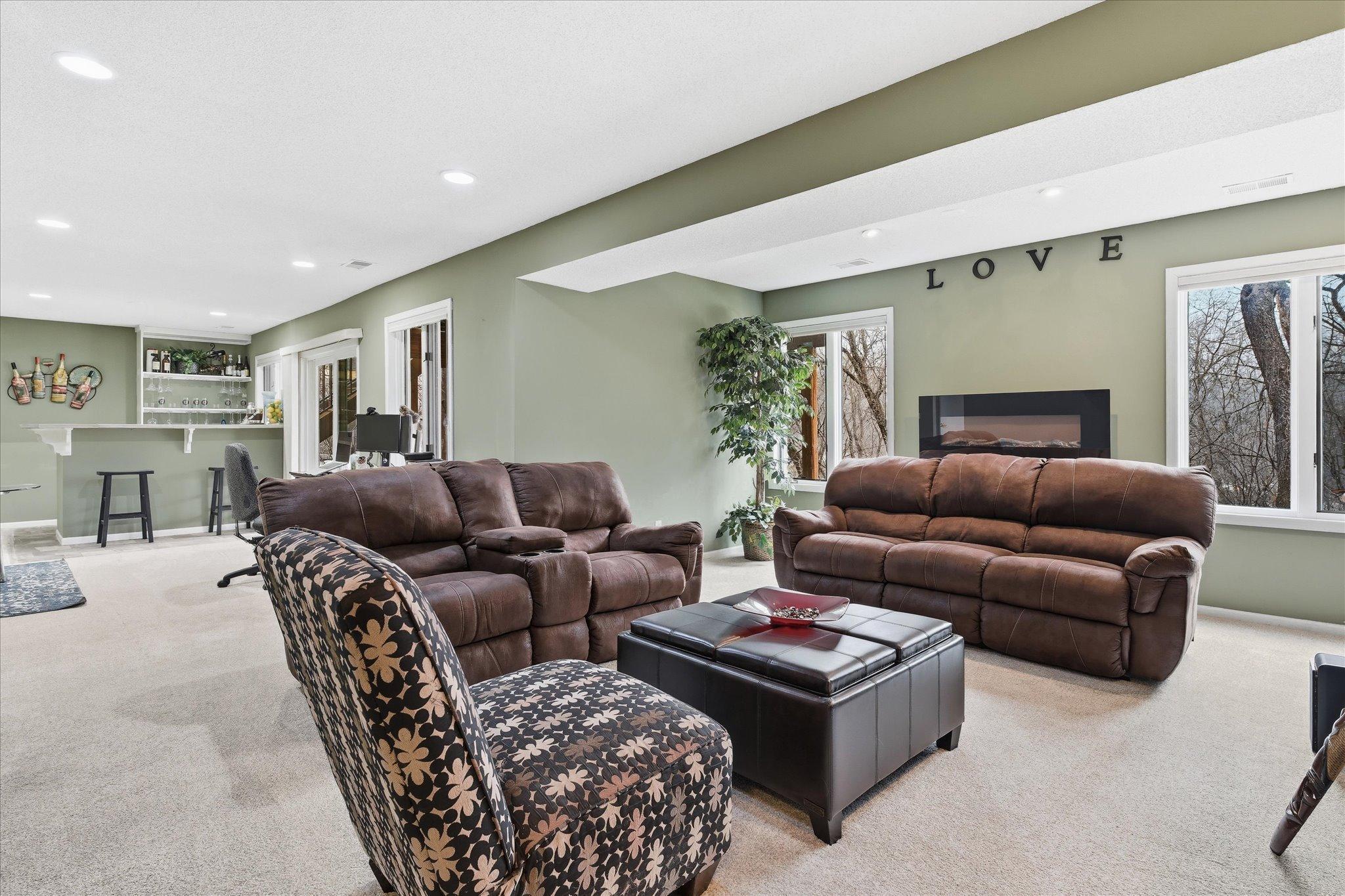 Inviting family area with an electric fireplace, and an ideal spot for TV watching or unwinding after a long day.