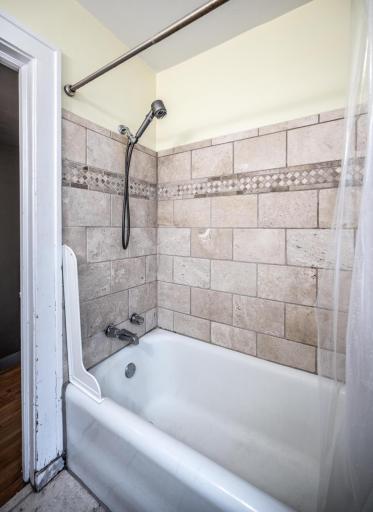 Upper level full bath with tile floor & tile surround