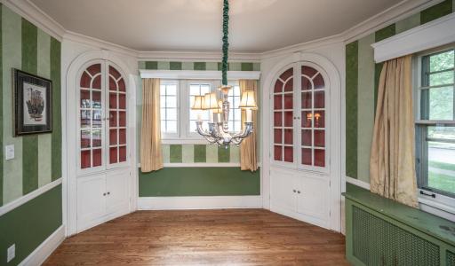Formal dining room with built in cabinets/shelving & solid hardwood flooring