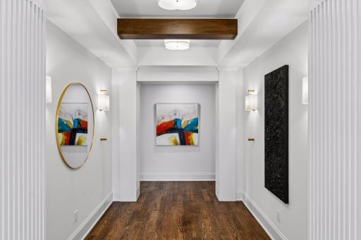 Upstairs landing features sconce lighting and beams throughout making this a standout