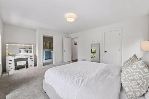 Spacious jack and Jill bedrooms each feature privacy shades walk in closets with custom closet systems