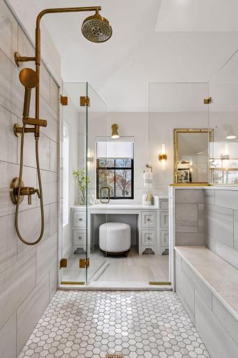 Primary bathroom retreat features in floor heat, free standing soaking tub and walk through tiled shower