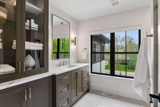 Ensuite bathroom with custom cabinetry and tiled walk in shower