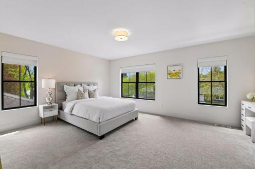 Spacious jack and Jill bedrooms each feature privacy shades walk in closets with custom closet systems