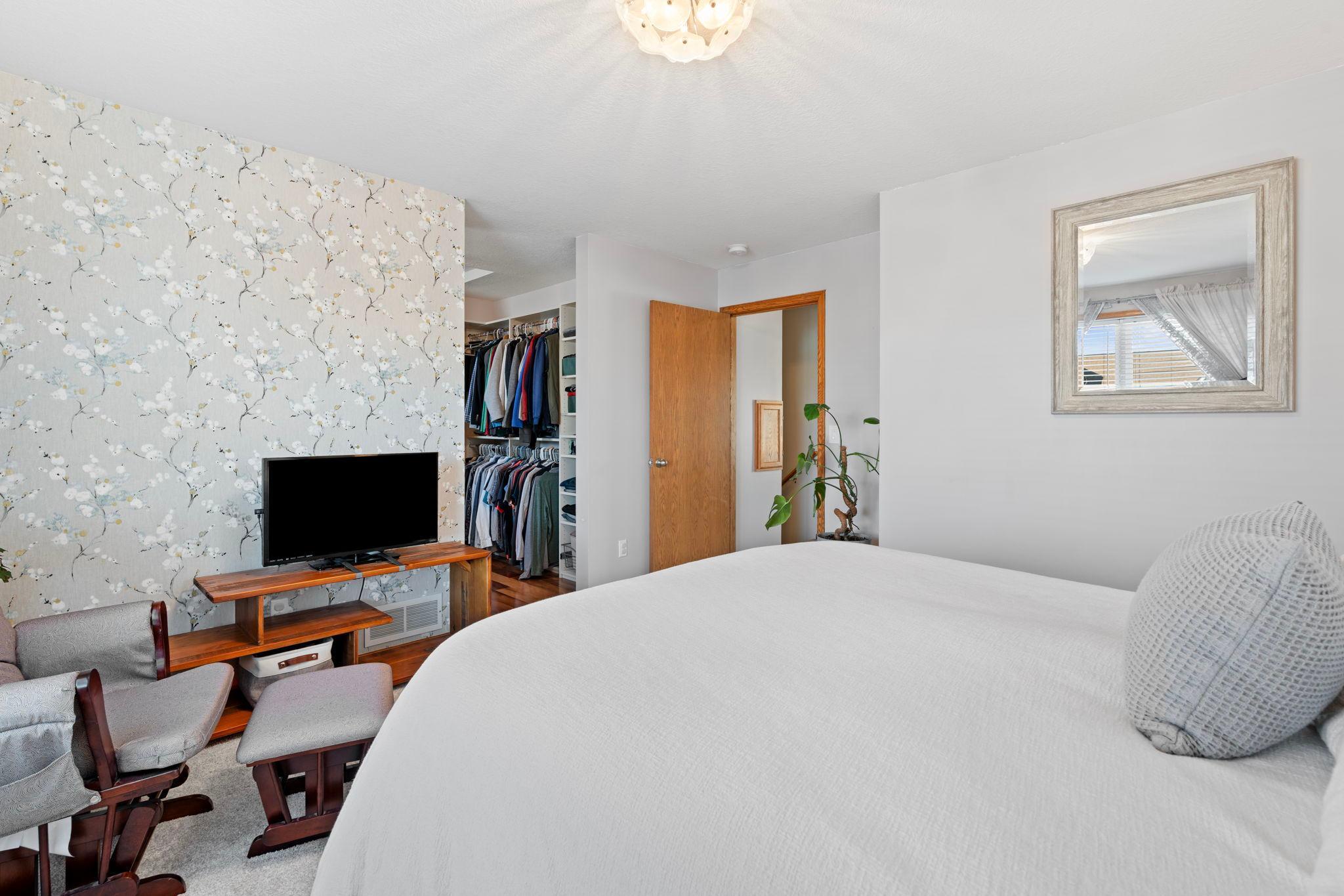 Upper level primary bedroom with spacious walk in closet.