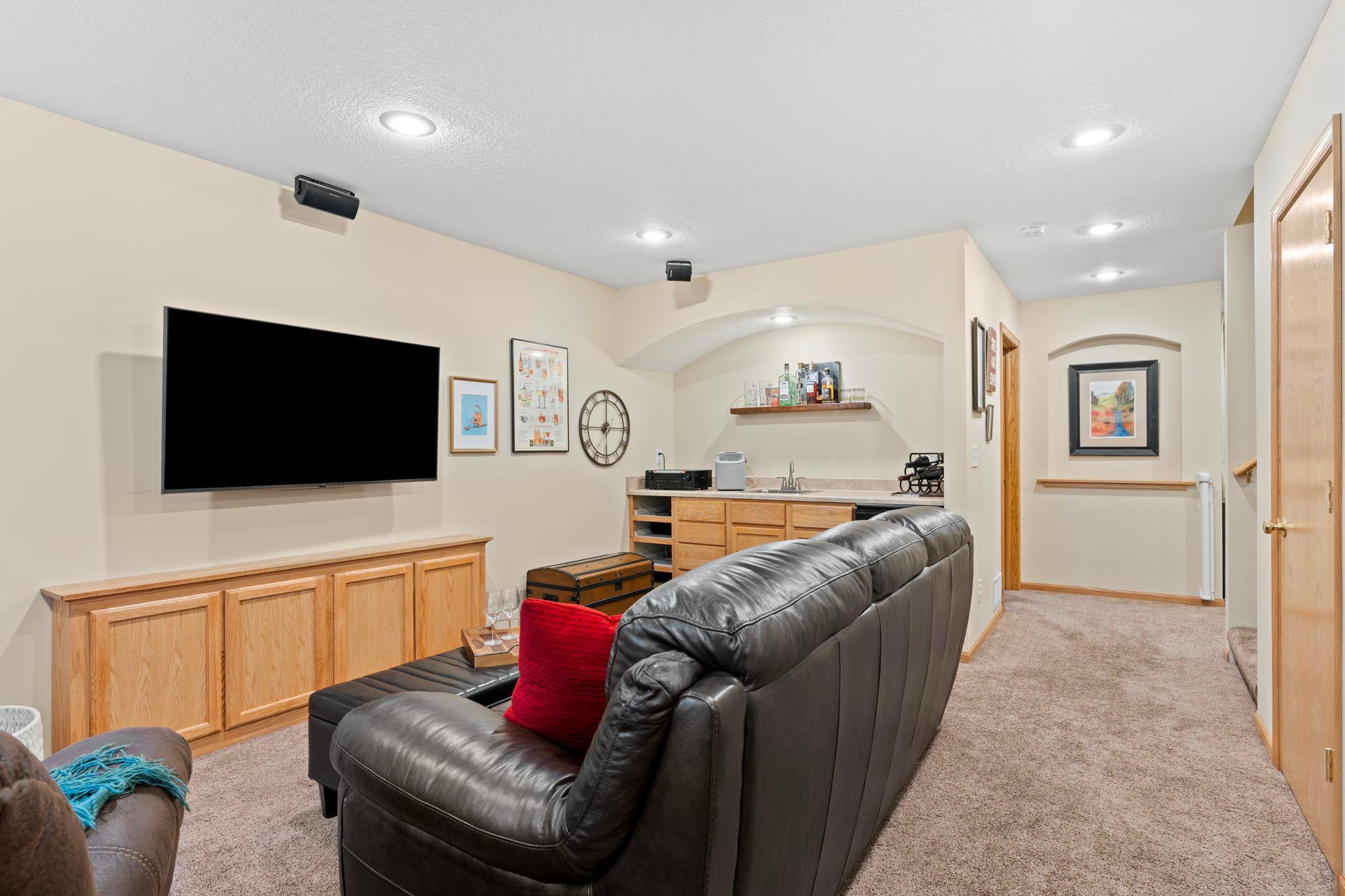 Ideal space for movie night or entertaining with a convenient wet bar.