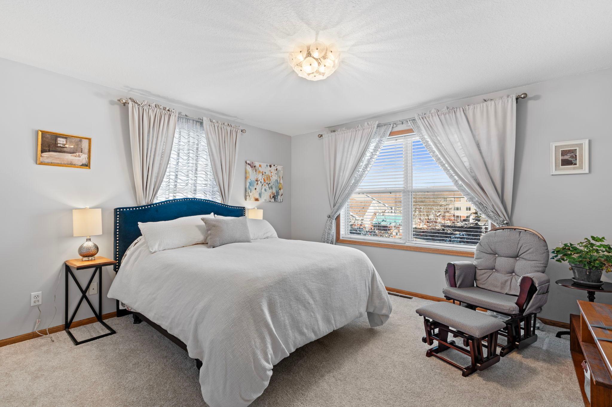 Upper level primary bedroom with spacious walk in closet. New upper level carpet.