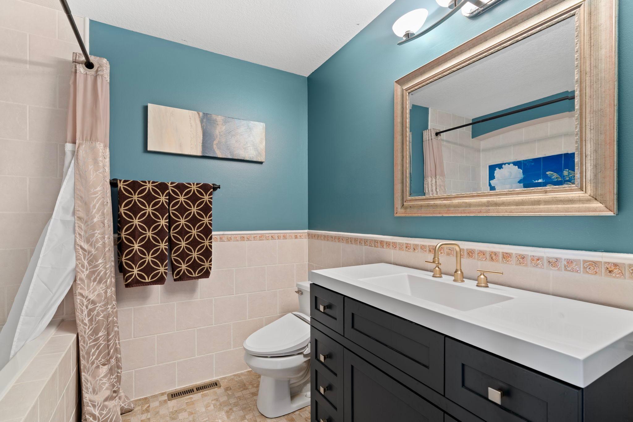 Upper level full bathroom with lovely new vanity and jetted tub.