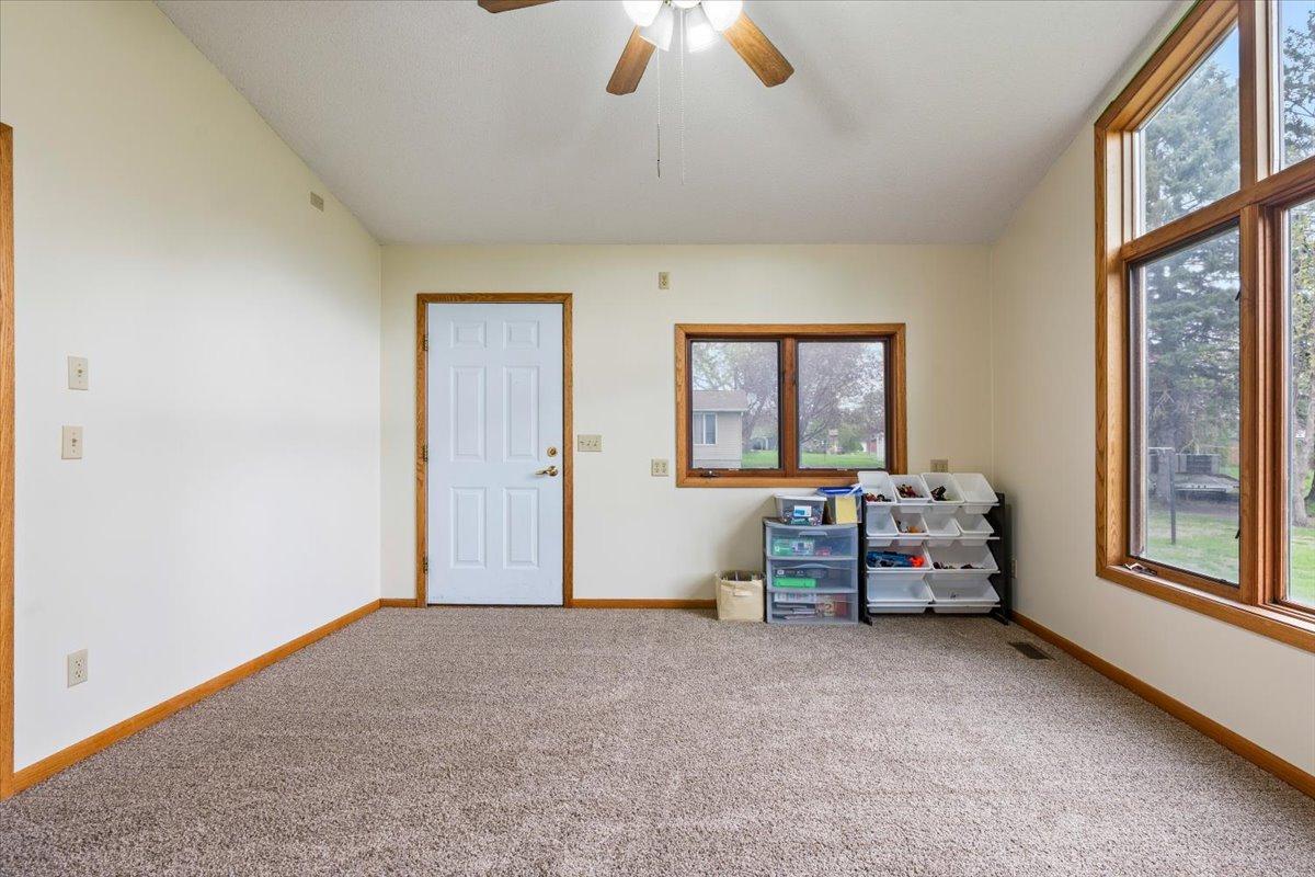 Sunroom with exterior door to backyard