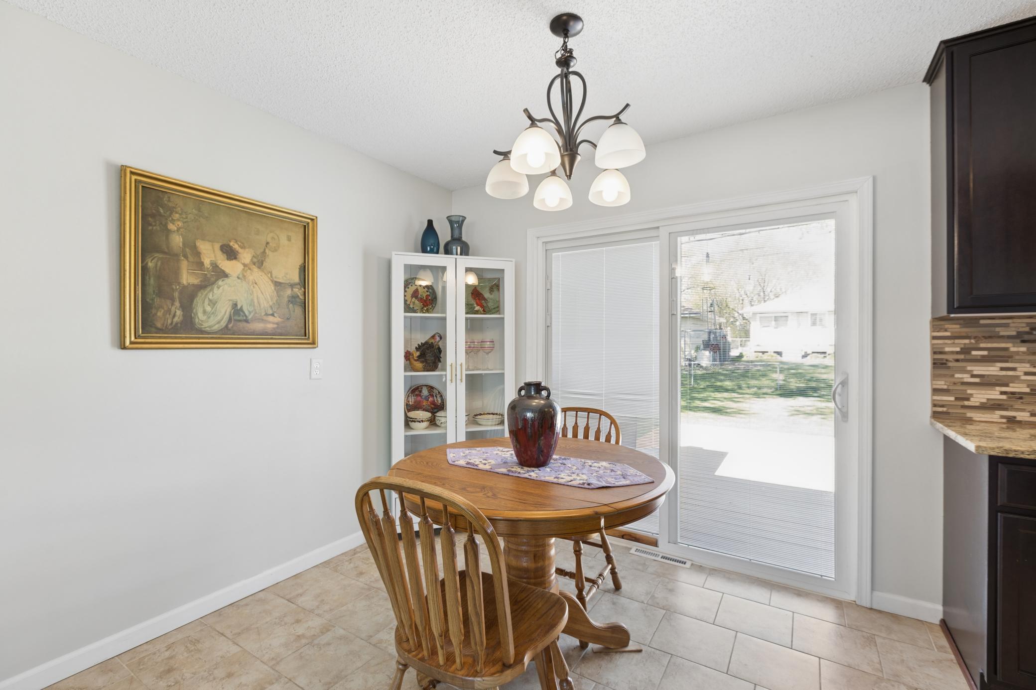 Dining area overlooks fenced yard