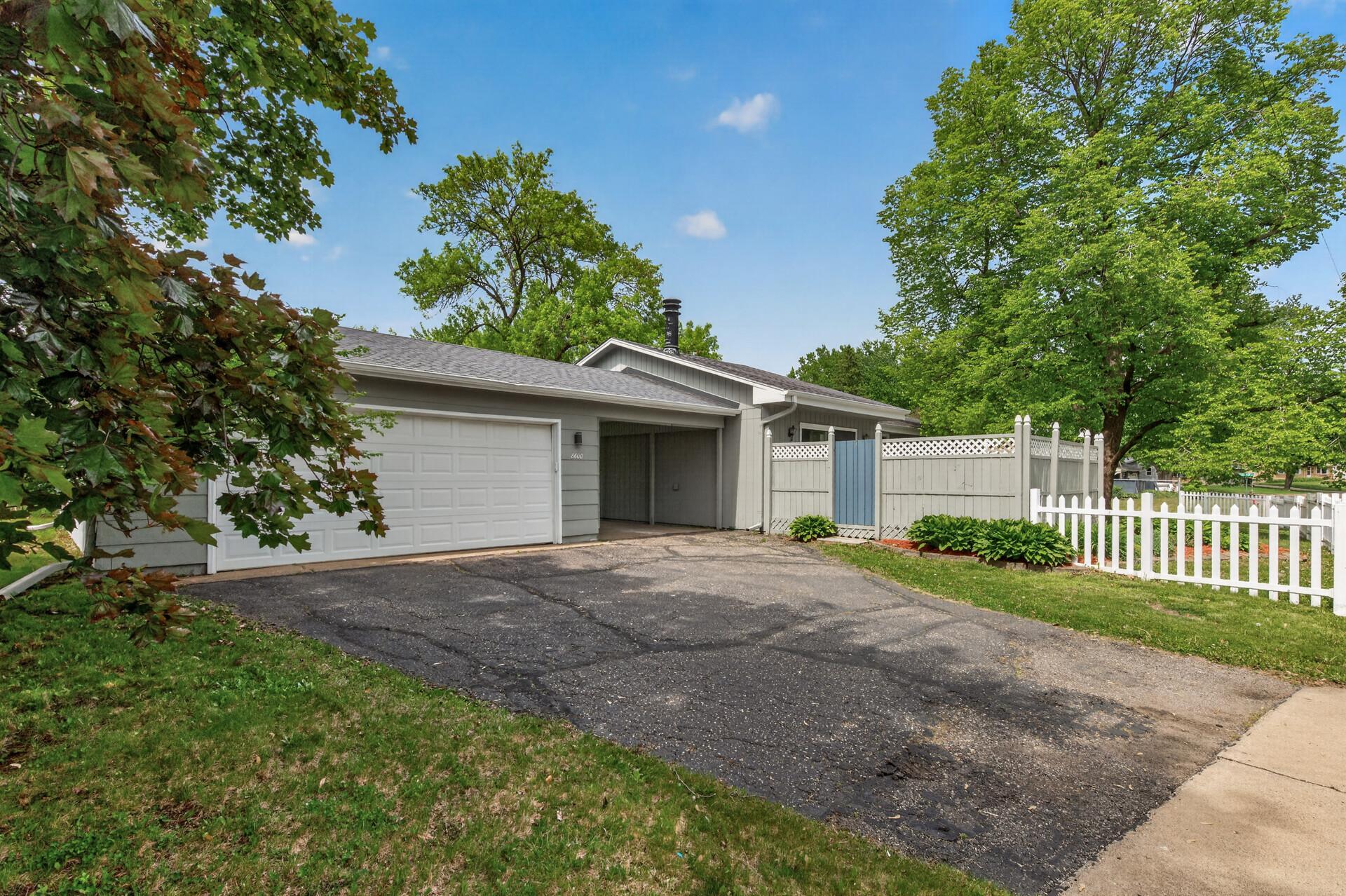 Covered breezeway + picket fence + park across the street = the kind of setup buyers instantly fall in love with.