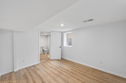 Clean, bright, and thoughtfully finished lower-level bedroom.