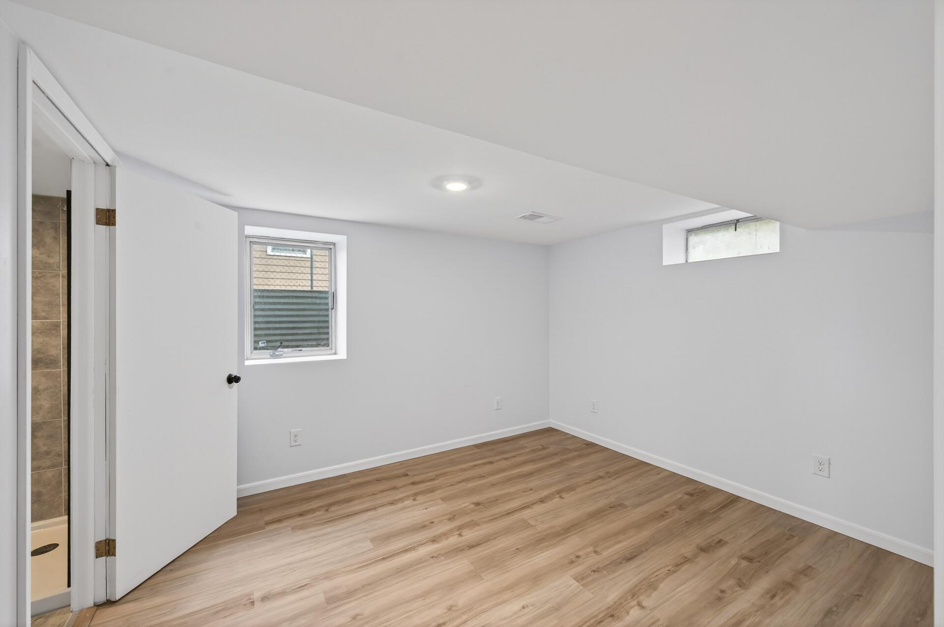 Newly added lower-level bedroom adds flexibility for guests or office use.jpg